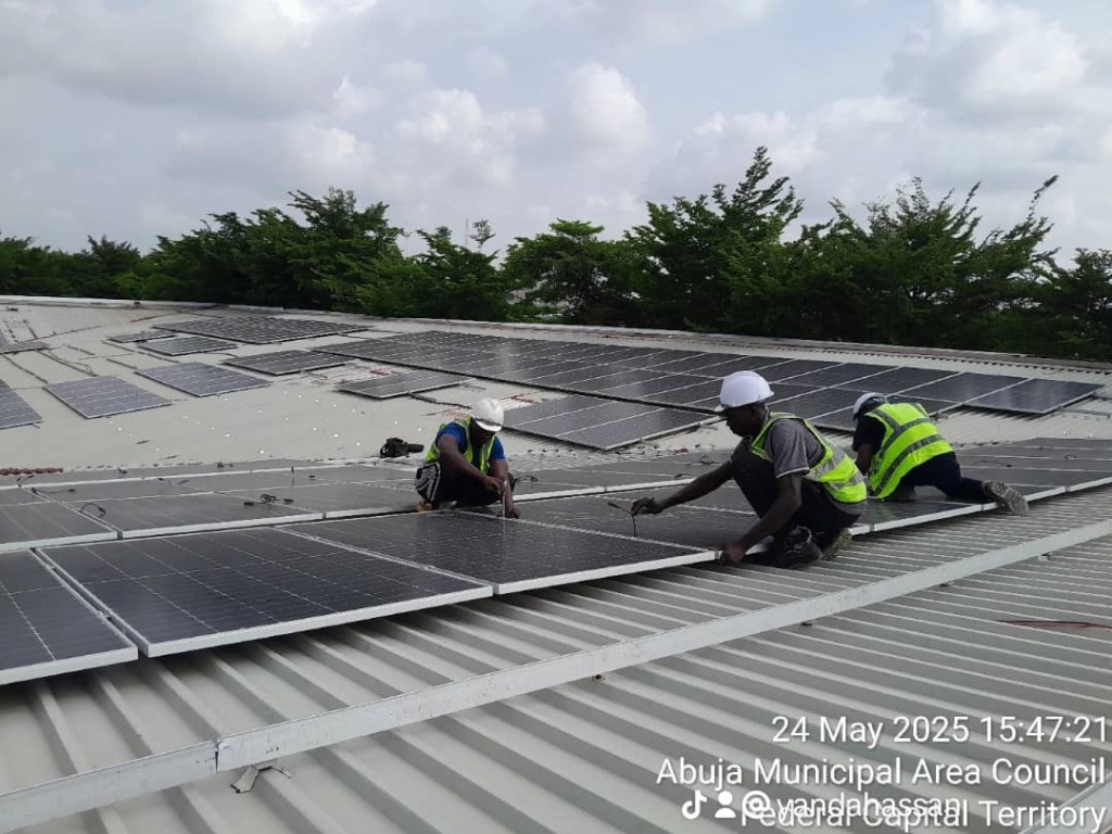 Jacbit team installing solar panels on a commercial rooftop in Abuja